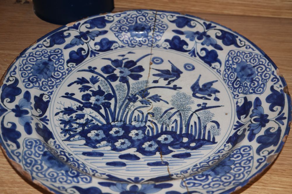Four 18th century Delft blue and white dishes, largest 35cm (a.f.)
